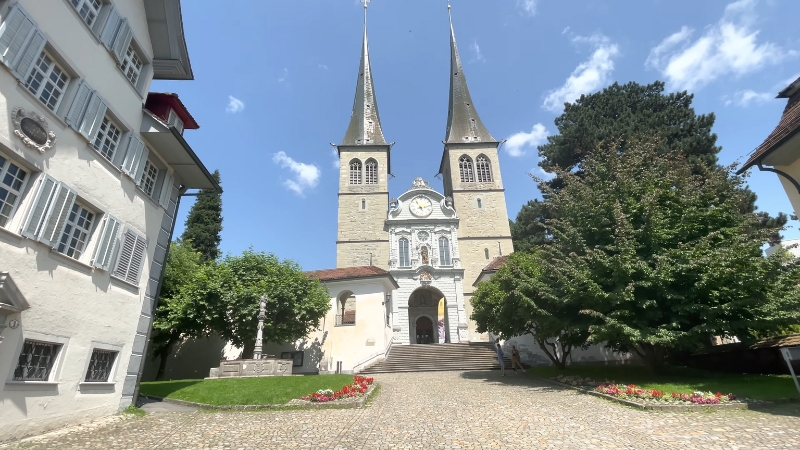 The Church of St. Leodegar in Lucerne, showcasing its twin spires and grand entrance
