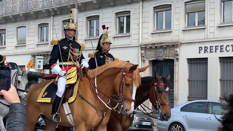 Members of France's Republican Guard on horseback, wearing ceremonial uniforms with helmets