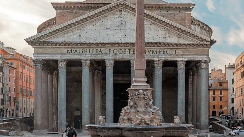 The image shows the Pantheon in Rome, featuring its grand portico with large columns and the obelisk in front
