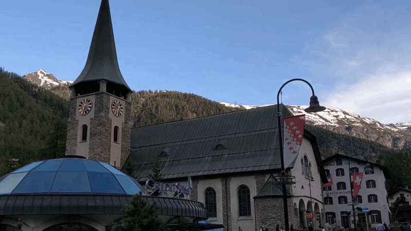 St. Martin's Church in Zermatt, Valais, framed by the surrounding mountains and modern architecture